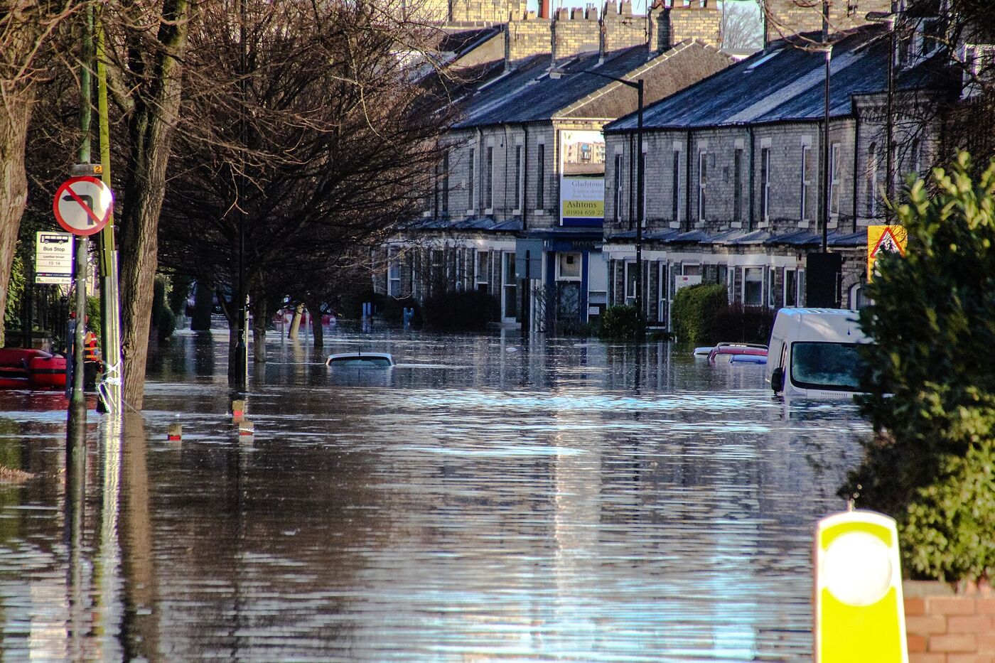 Illustrative photo of a flooded residential street after heavy rain; not Anderson, Indiana, and not a Anderson Water Damage project.